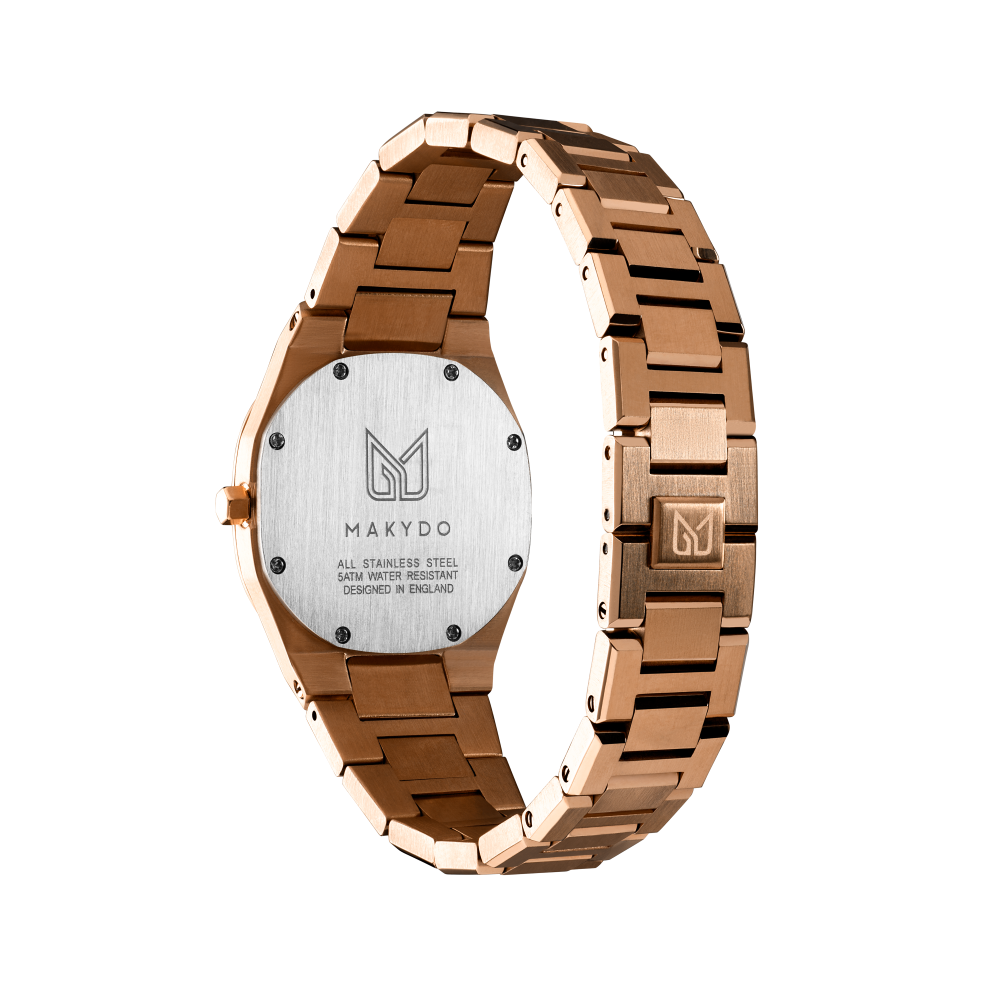 Makydo's rose gold white dial women's watch is finely colored, eye-catching allure captivates effortlessly, making it the perfect companion for both special occasions and everyday elegance. The brilliant, highly transparent sapphire crystal with anti-reflective coating expose the sophisticated silver baton hands with BGW9 Lume. The flawless symmetry of perfected Rose Gold plated 316L stainless steel integrated bracelet complimented with a 6.7mm of slim case powered by a sturdy Miyota quartz movement.