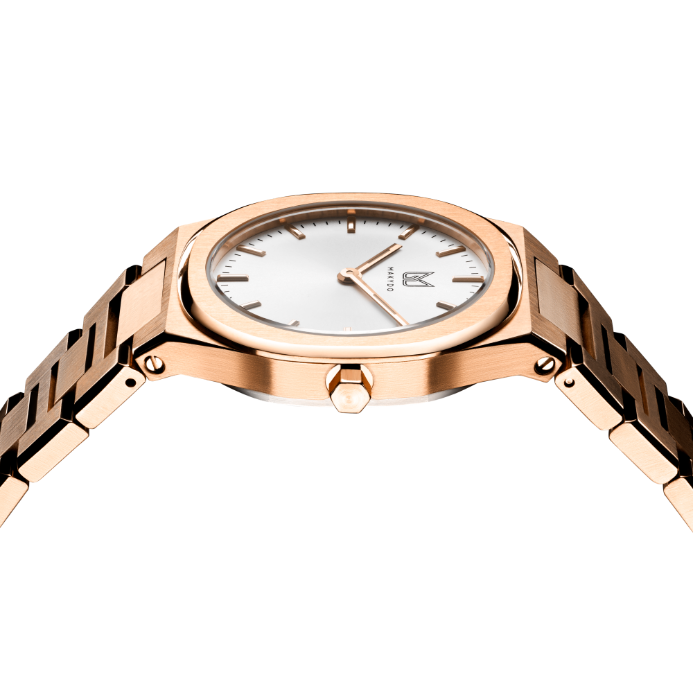 Makydo's rose gold white dial women's watch is finely colored, eye-catching allure captivates effortlessly, making it the perfect companion for both special occasions and everyday elegance. The brilliant, highly transparent sapphire crystal with anti-reflective coating expose the sophisticated silver baton hands with BGW9 Lume. The flawless symmetry of perfected Rose Gold plated 316L stainless steel integrated bracelet complimented with a 6.7mm of slim case powered by a sturdy Miyota quartz movement.