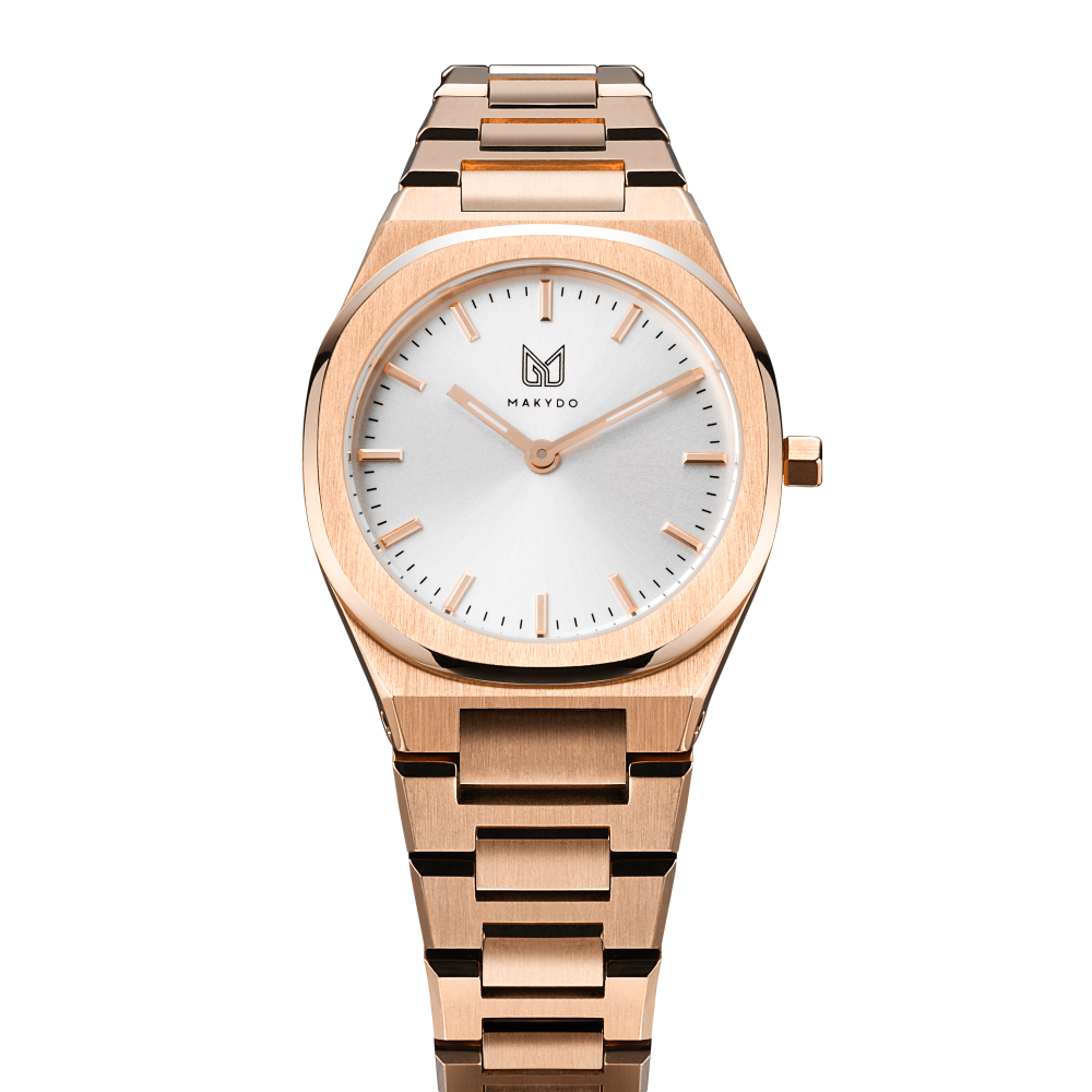 Makydo's rose gold white dial women's watch is finely colored, eye-catching allure captivates effortlessly, making it the perfect companion for both special occasions and everyday elegance. The brilliant, highly transparent sapphire crystal with anti-reflective coating expose the sophisticated silver baton hands with BGW9 Lume. The flawless symmetry of perfected Rose Gold plated 316L stainless steel integrated bracelet complimented with a 6.7mm of slim case powered by a sturdy Miyota quartz movement.