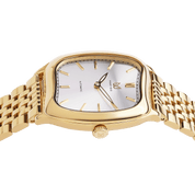Gold wristwatch with a white face on a white background
