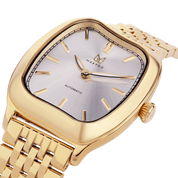 Gold wristwatch with a silver face on a white background