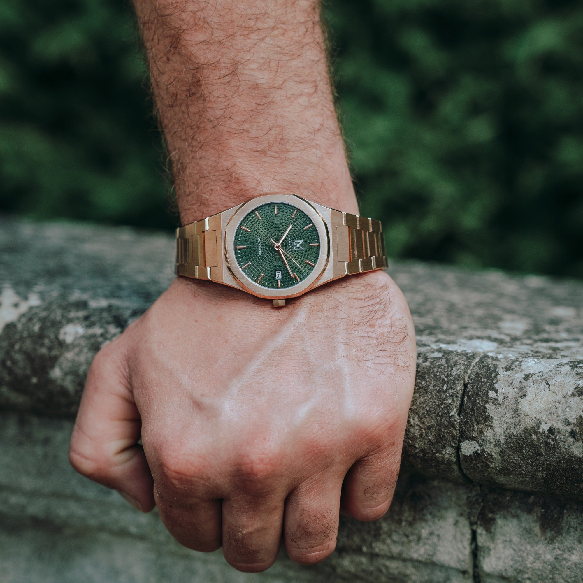Wrist shot of man wearing MAKYDO Rose Gold Green Mosaic 38 automatic unisex watch, featuring green mosaic pattern dial.  316L Stainless Steel integrated bracelet complimented with a 9mm of slim case powered by a sturdy Japan MIYOTA 9015 movement.
