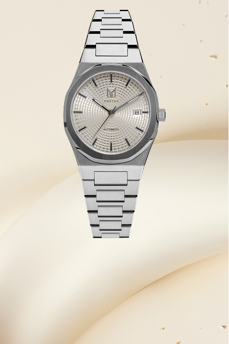Silver watch with a detailed face on a beige background