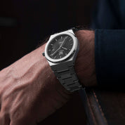 Wrist shot of Man wearing MAKYDO Onyx Black Mosaic 38 automatic unisex watch, featuring black mosaic pattern dial.  316L Stainless Steel integrated bracelet complimented with a 9mm of slim case powered by a sturdy Japan MIYOTA 9015 movement.