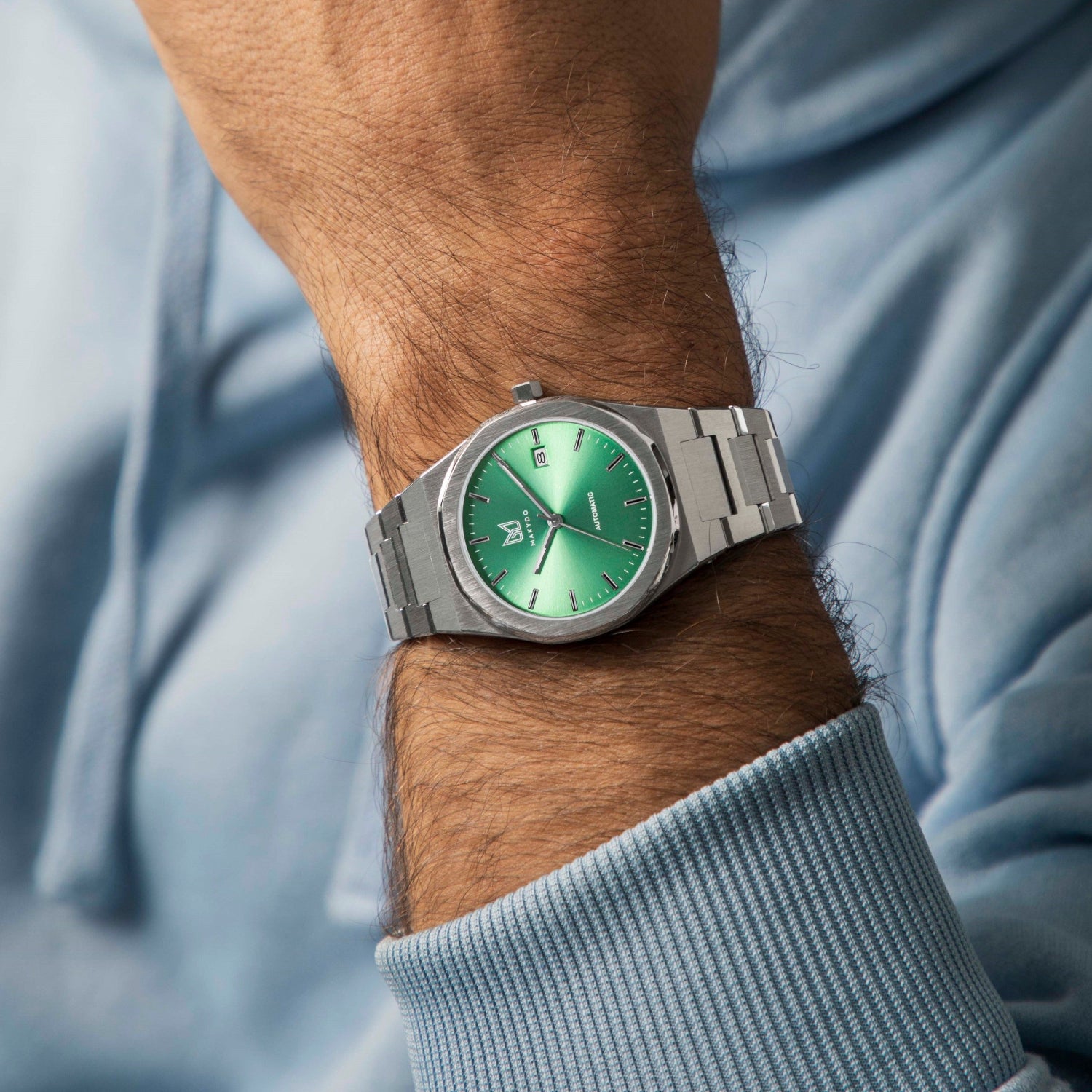 Wrist shot of MAKYDO Absinthe Green 38 automatic unisex watch, featuring a Green sunburst dial.  316L Stainless Steel integrated bracelet complimented with a 9mm of slim case powered by a sturdy Japan MIYOTA 9015 movement.