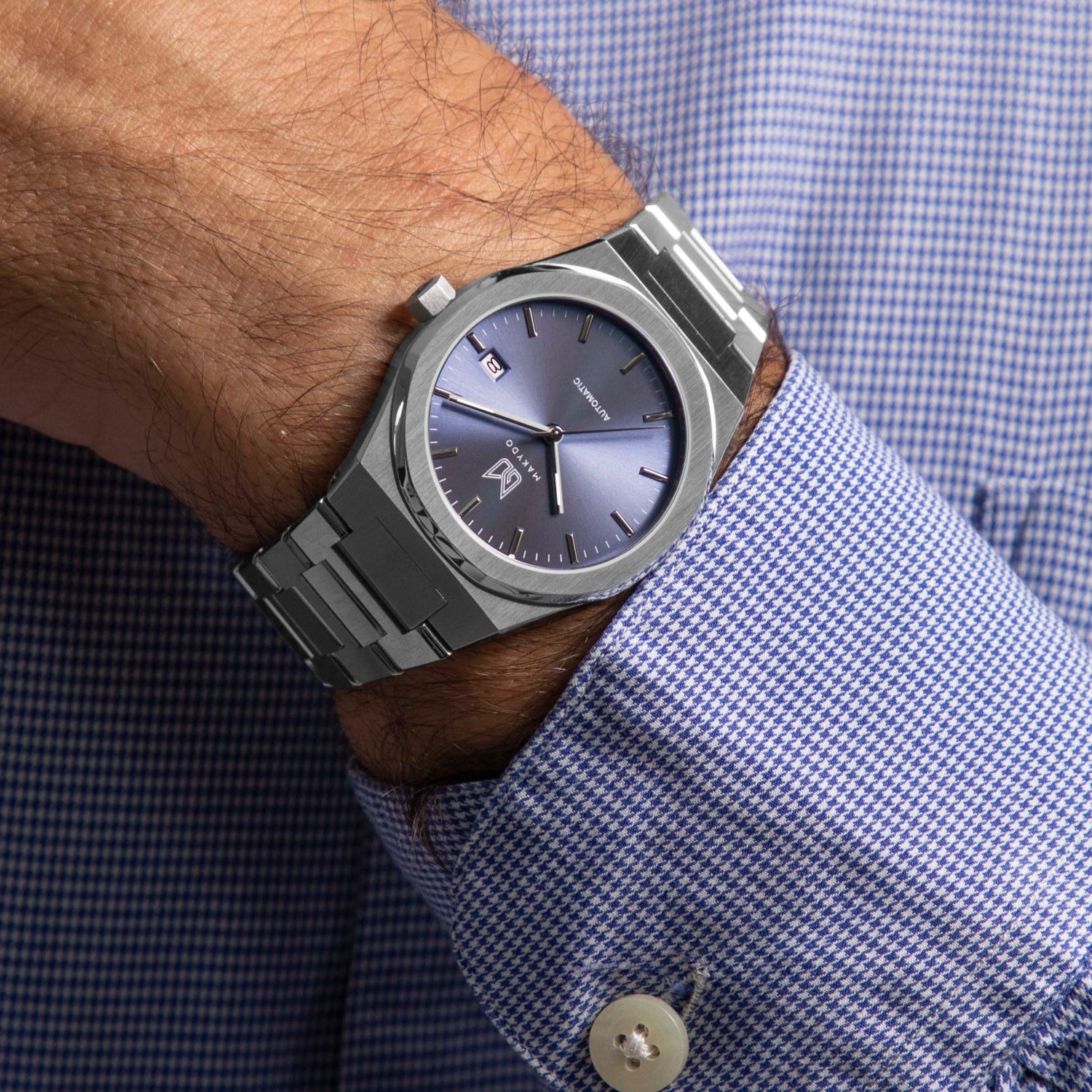 Wrist shot of MAKYDO Mystic Blue 38 automatic unisex watch, featuring a light blue sunburst  dial.  316L Stainless Steel integrated bracelet complimented with a 9mm of slim case powered by a sturdy Japan MIYOTA 9015 movement.